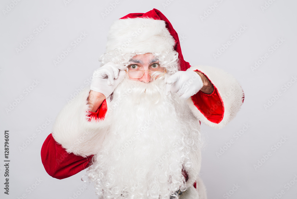 funny smiling Santa Claus showing with finger to the camera