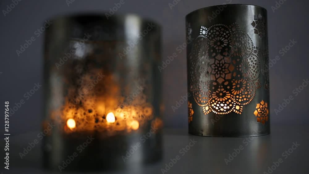 Two ornamental lanterns with burning candles. Festive glittering bokeh lights background for hygge Two ornamental lanterns with burning candles. Festive glittering bokeh lights background for hygge