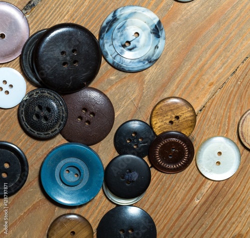 Buttons lying on old wooden floor.