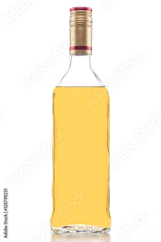 Isolated gold tequila bottle, clear tall alcohol bottle full of yellow liquid on a white background