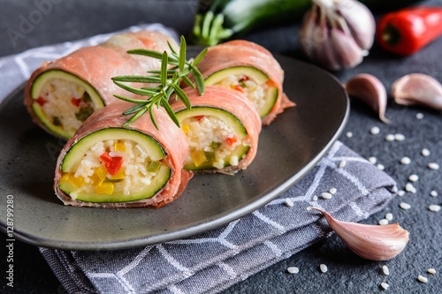 Roasted zucchini stuffed with rice, cheese, pepper and wrapped in Prosciutto slices