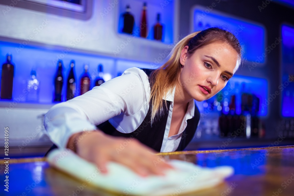 Barmaid cleaning counter Barmaid cleaning counter