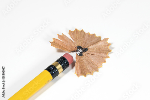 wooden pencil shavings on white paper background photo