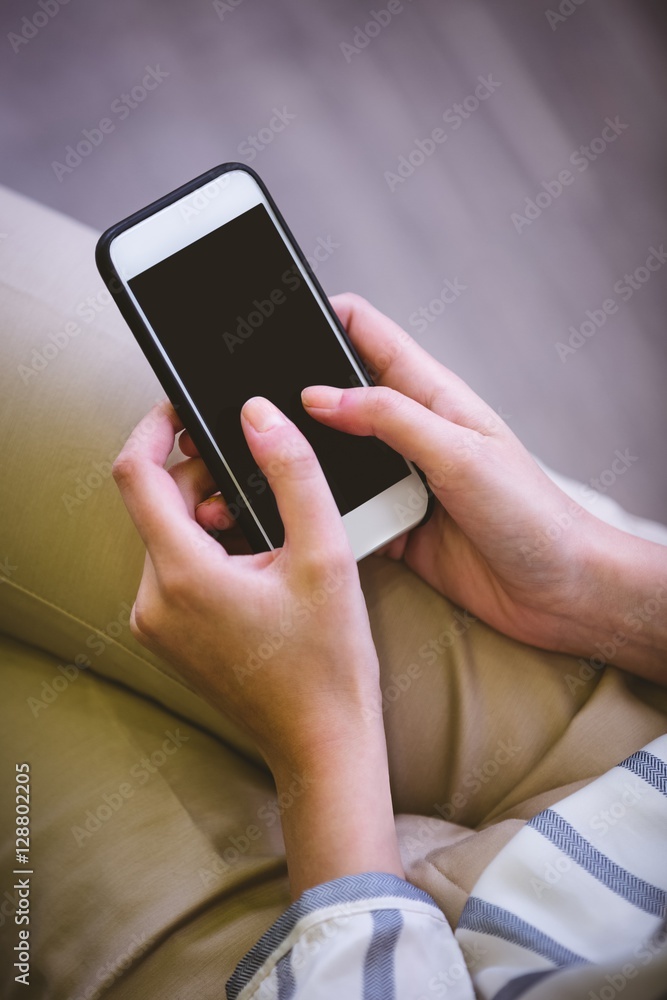 Midsection of businesswoman using cellphone at office Midsection of businesswoman using cellphone at office