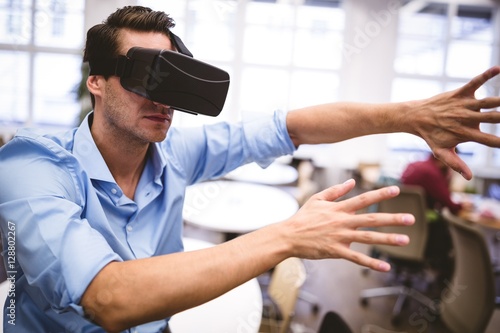Executive using virtual reality glasses at office