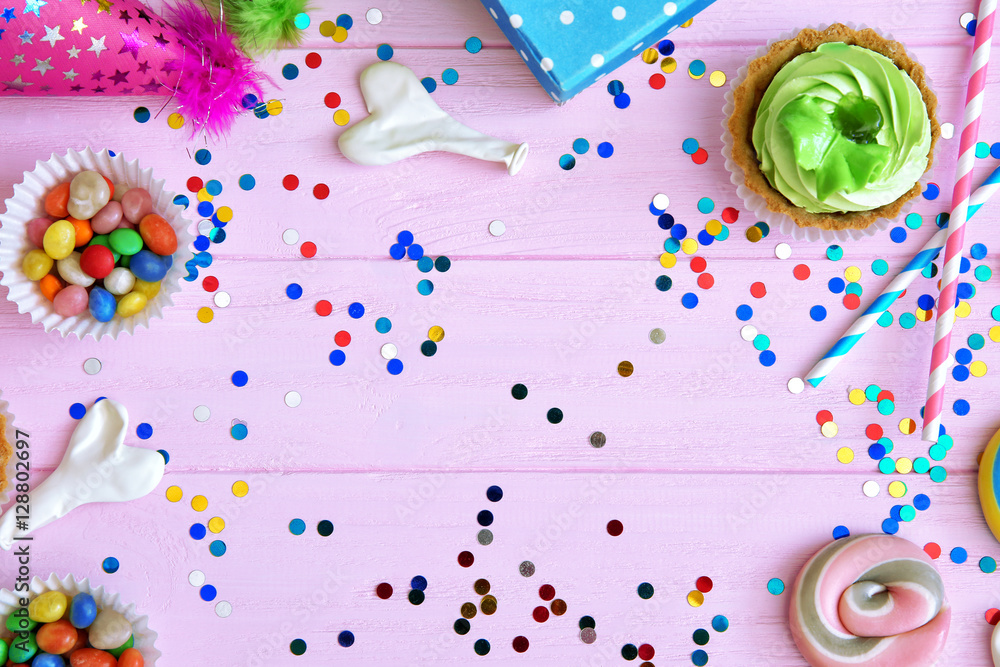 Birthday party objects on pink wooden background, top view Birthday party objects on pink wooden background, top view