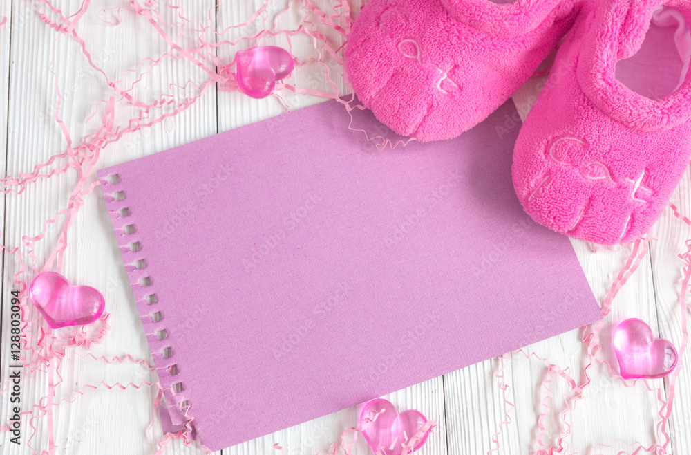 pink baby's bootees on wooden background pink baby's bootees on wooden background