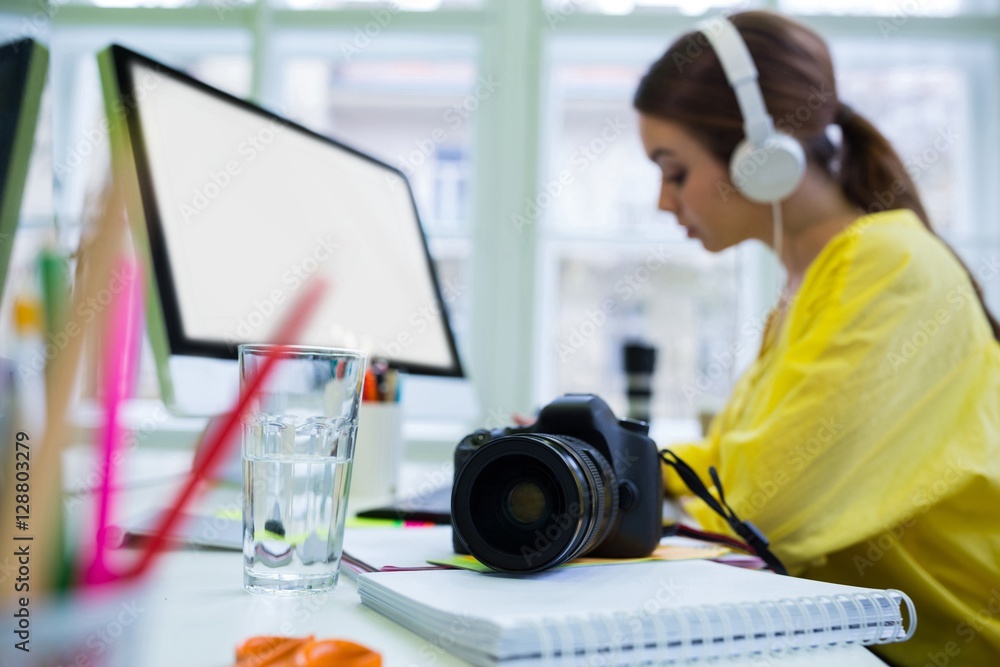 Close-up of camera on desk with executive working at office