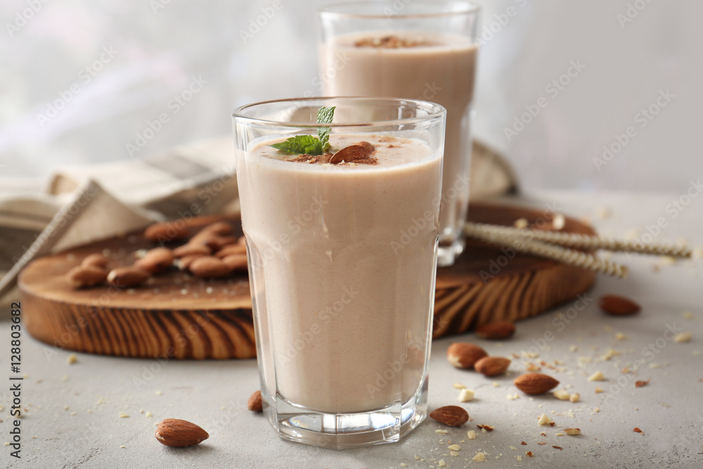 Glass with delicious nut milk shake on table, closeup Glass with delicious nut milk shake on table, closeup