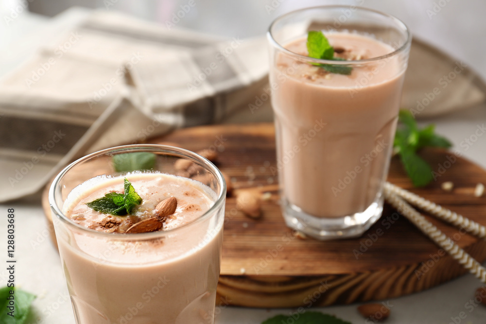 Glasses with delicious nut milk shake on table, closeup Glasses with delicious nut milk shake on table, closeup