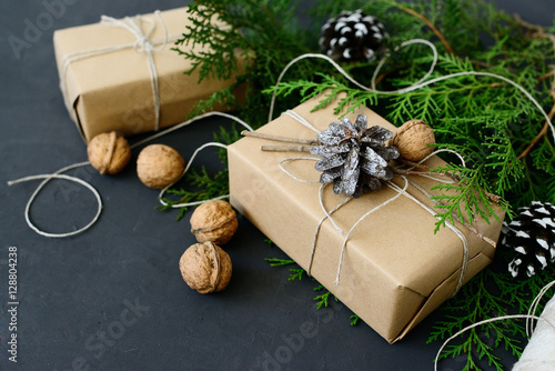 Wrapping rustic eco Christmas gifts with craft paper, string and