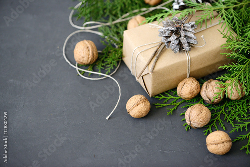 Wrapping rustic eco Christmas packages with brown paper, string