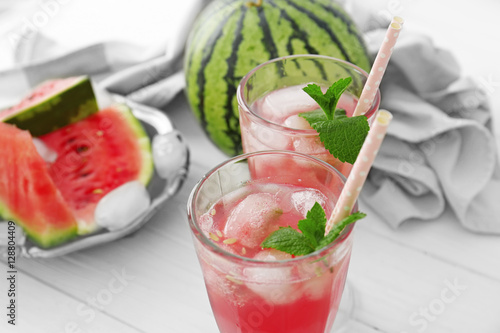 Watermelon with cocktails on light background