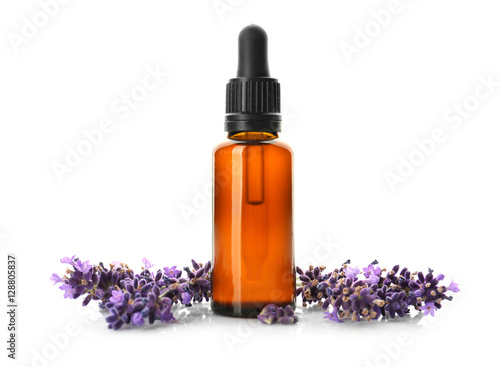 Bottle with aroma oil and lavender flowers isolated on white