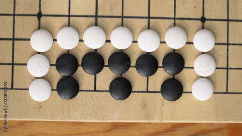 Chinese Go or Weiqi board game. Living at the side position with two eyes. Outside activity.