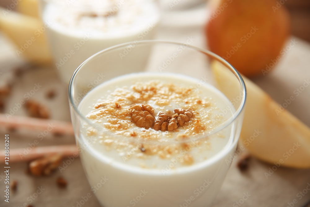 Tasty milk shake with walnut on table Tasty milk shake with walnut on table