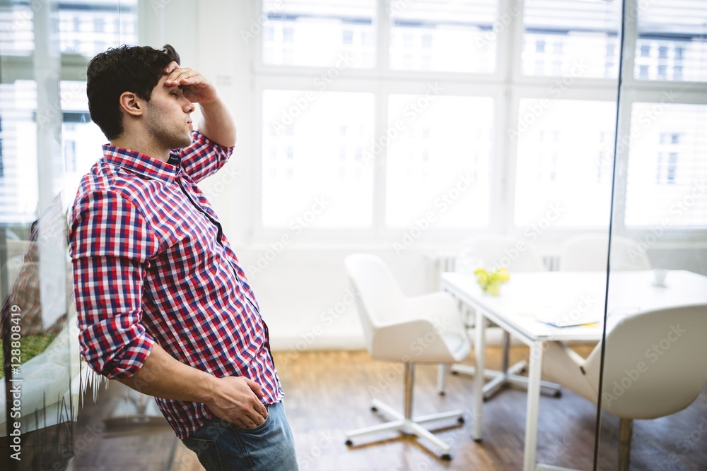 Upset businessman leaning on glass Upset businessman leaning on glass