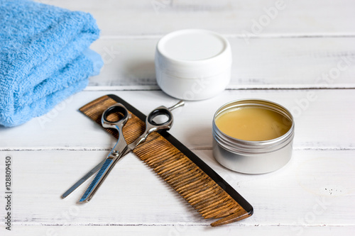 Men's cosmetics for hair care on wooden background