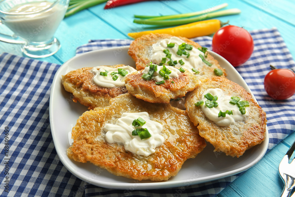 Plate with tasty potato pancakes for Hanukkah on wooden table, closeup Plate with tasty potato pancakes for Hanukkah on wooden table, closeup