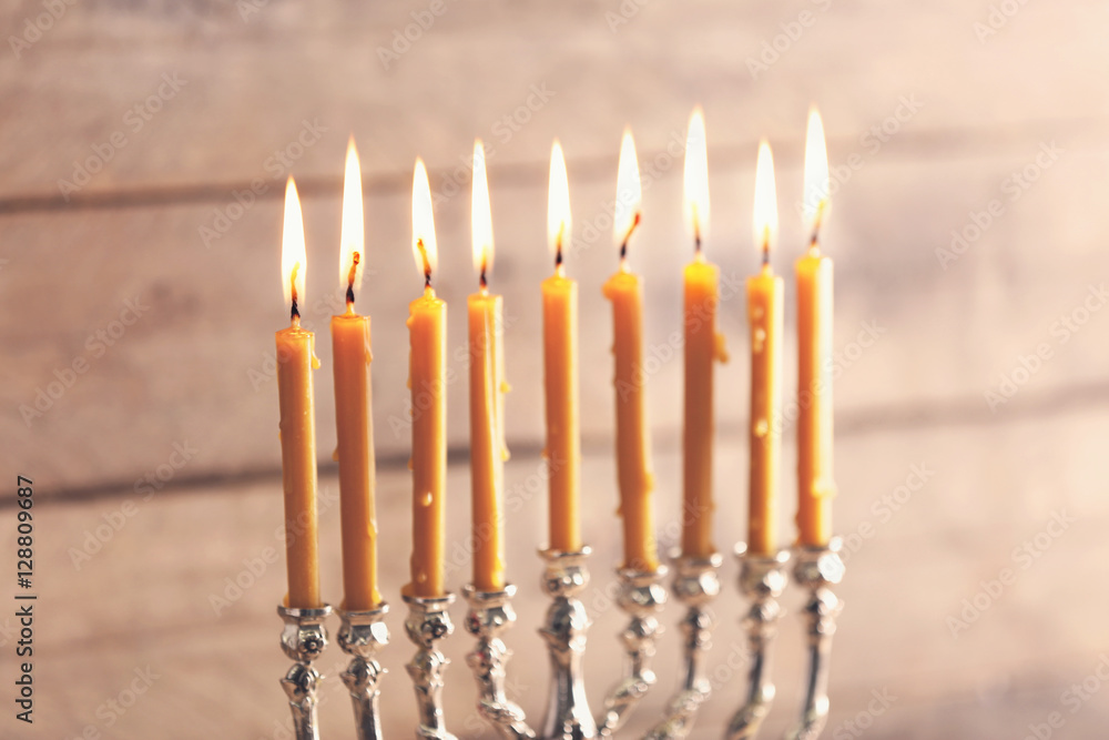 Menorah with candles for Hanukkah on blurred wooden background, close up Menorah with candles for Hanukkah on blurred wooden background, close up