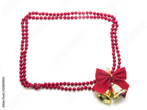 Frame made of pearls with red bow and christmas bells isolated o