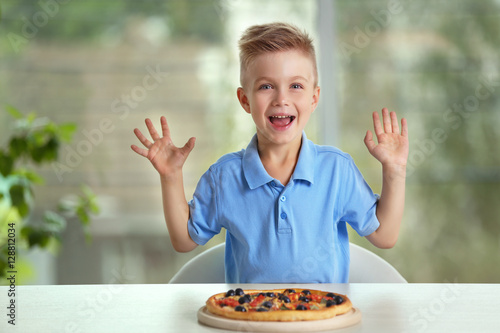 Cute boy with hot pizza at ...
