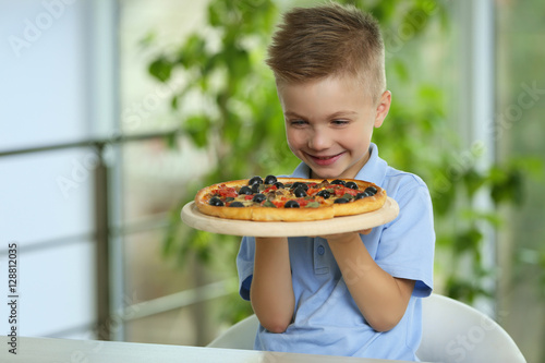 Cute boy with hot pizza at ...
