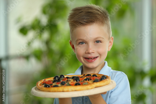 Cute boy with hot pizza at ...
