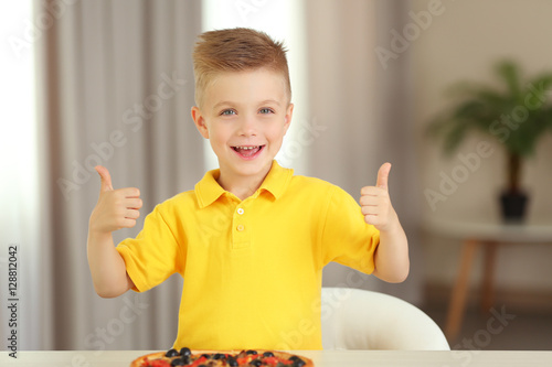 Cute boy with hot pizza at ...