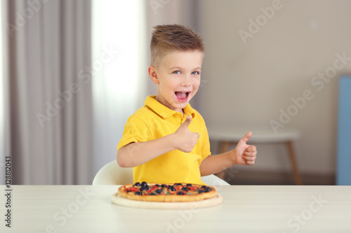 Cute boy with hot pizza at ...