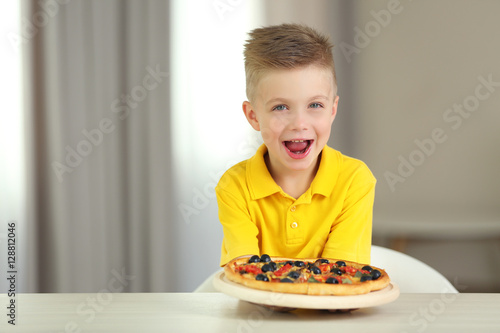 Cute boy with hot pizza at ...