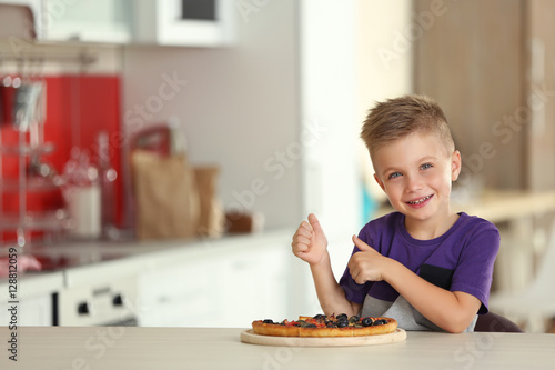Cute boy with hot pizza at ...