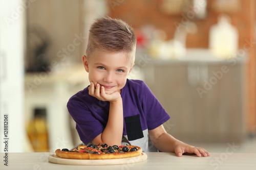 Cute boy with hot pizza at ...