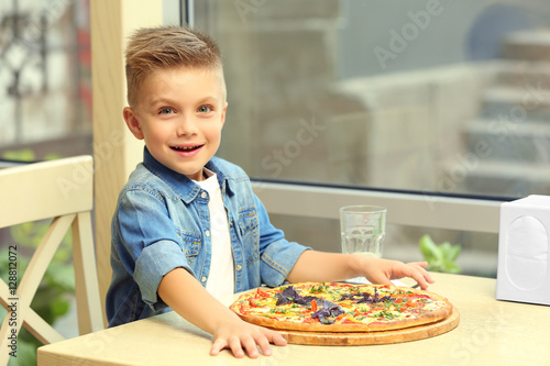 Cute boy with hot pizza in ...