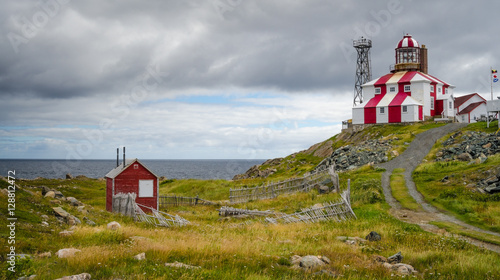 Cape Bonavista Lightstation, Newfoundland, Canada.  Lighthouse station LL 449, tip of cape Bonavista on Atlantic coast. Navigational aid to ships.  Beacon at end of rocky shoreline at cape's end.
  