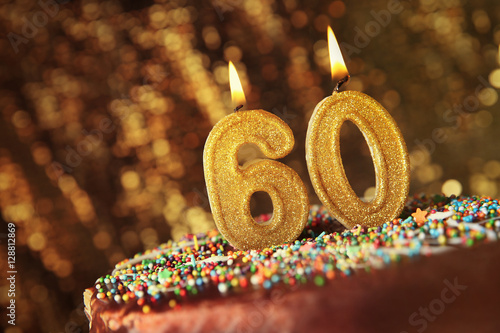 Birthday cake with burning candles on blurred background photo