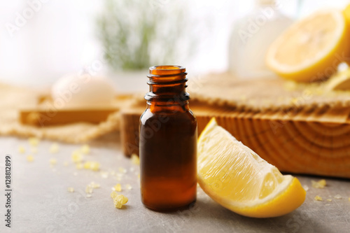 Beautiful spa composition with lemon essential oil on table, closeup