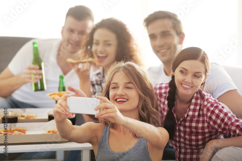 Friends taking selfie at ho...
