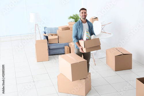 House moving concept. Man holding cardboard box, closeup © Africa Studio