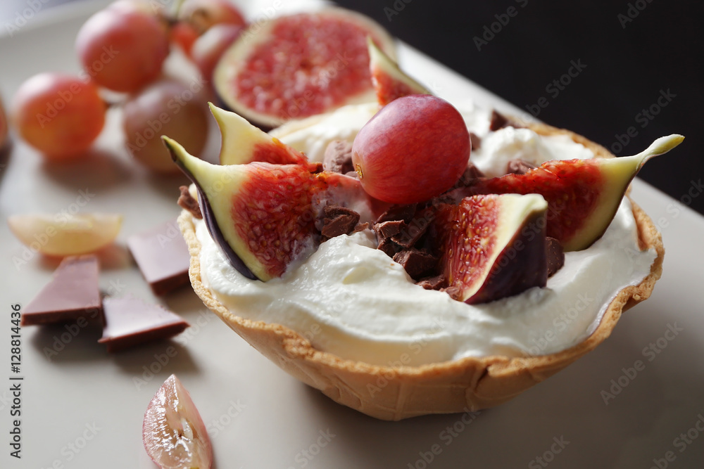 Fresh cake with figs, grapes and chocolate on table Fresh cake with figs, grapes and chocolate on table