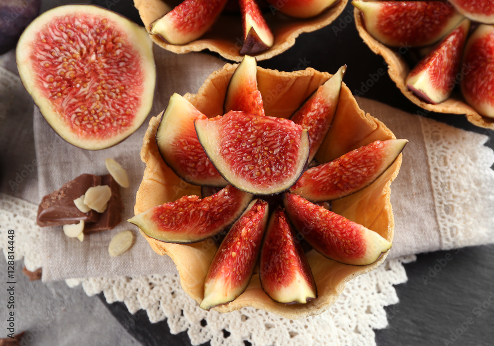 Tasty basket with fresh figs on napkin, closeup Tasty basket with fresh figs on napkin, closeup