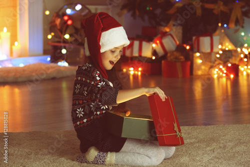 Little girl opening Christm...