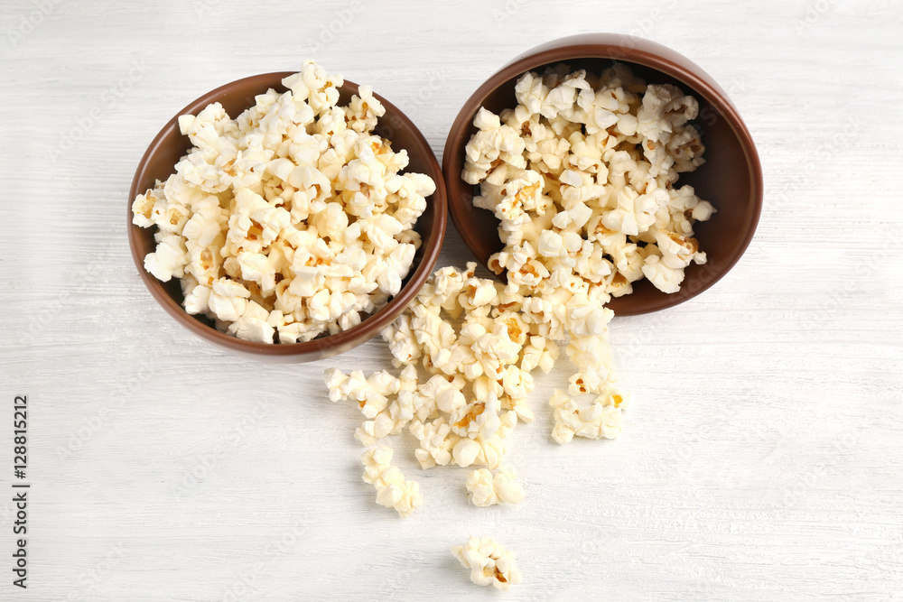 Pop corn in bowls on wooden table Pop corn in bowls on wooden table