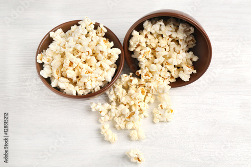 Pop corn in bowls on wooden table