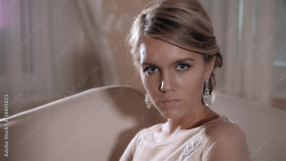 Beautiful smiling bride woman with long stylish hair posing in wedding dress at interior. Beauty indoor portrait. Beautiful smiling bride woman with long stylish hair posing in wedding dress at interior. Beauty indoor portrait.