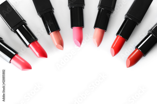 Assortment of lipsticks on white background, top view