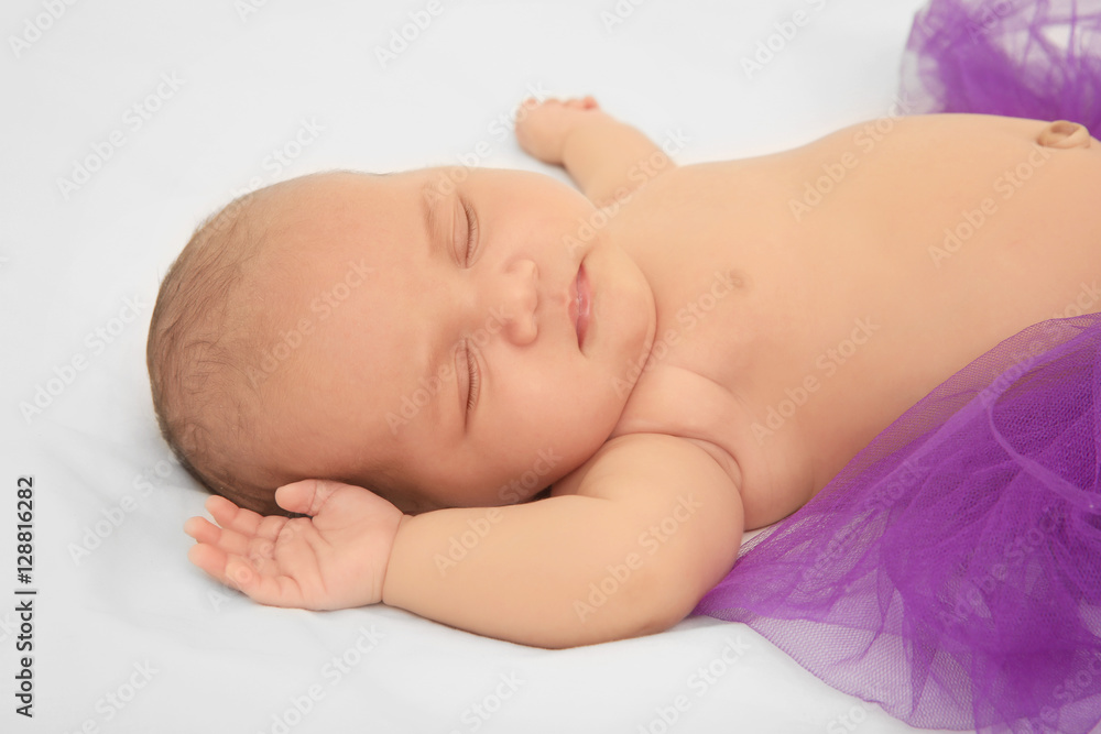 Cute baby in purple skirt sleeping on bed Cute baby in purple skirt sleeping on bed