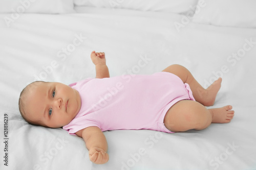 Cute baby lying on bed
