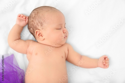 Cute baby in purple skirt s...