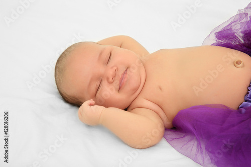 Cute baby in purple skirt s...